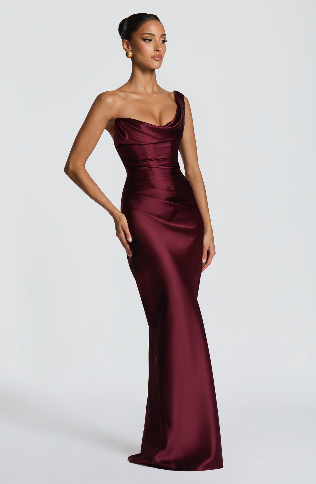 Chic women's one-shoulder burgundy maxi dress featuring a structured corset bodice & elegant lace-up back for evenings.