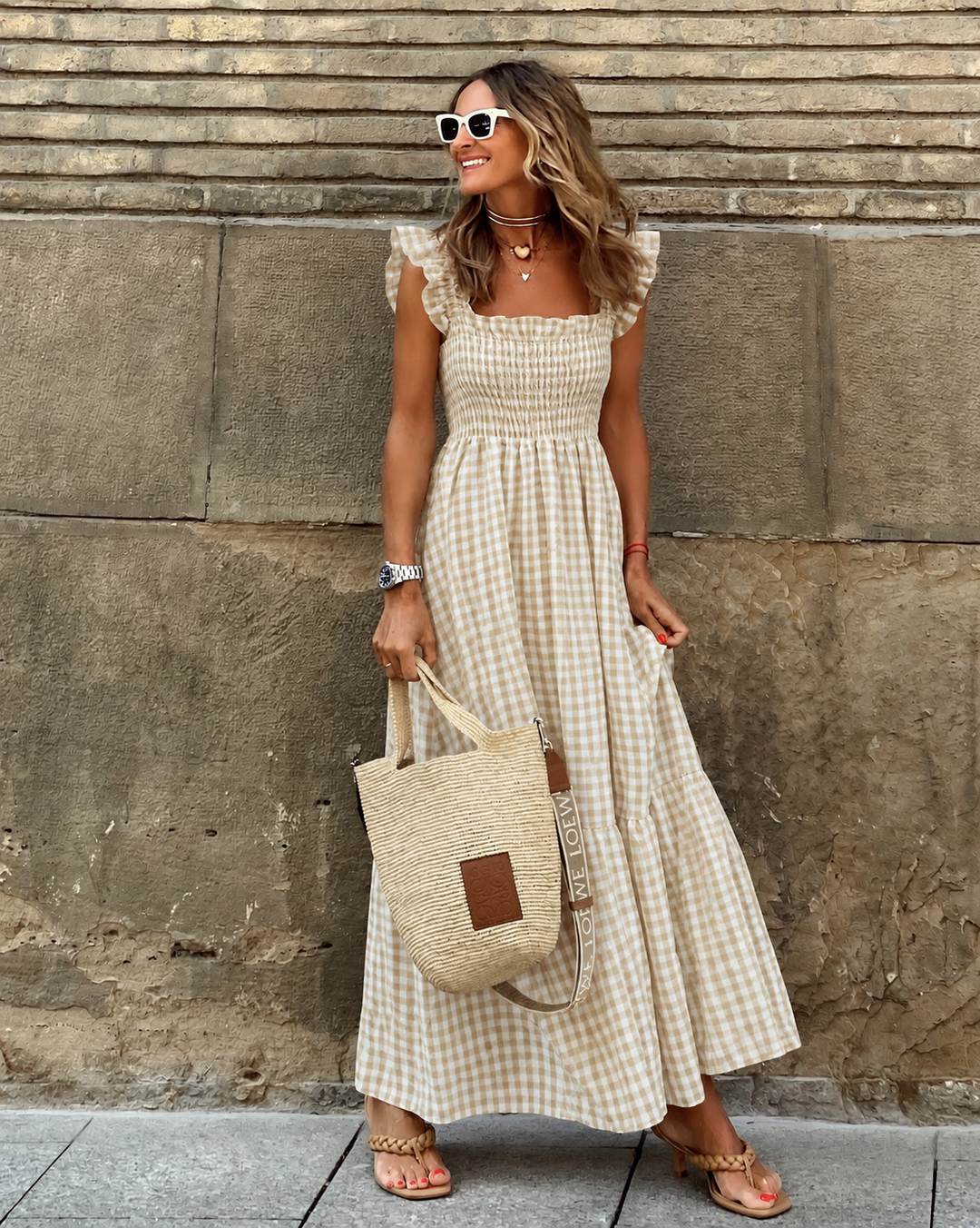 Women's flowy gingham maxi sundress with smocked bodice, tiered skirt, and cap sleeves for casual elegance.