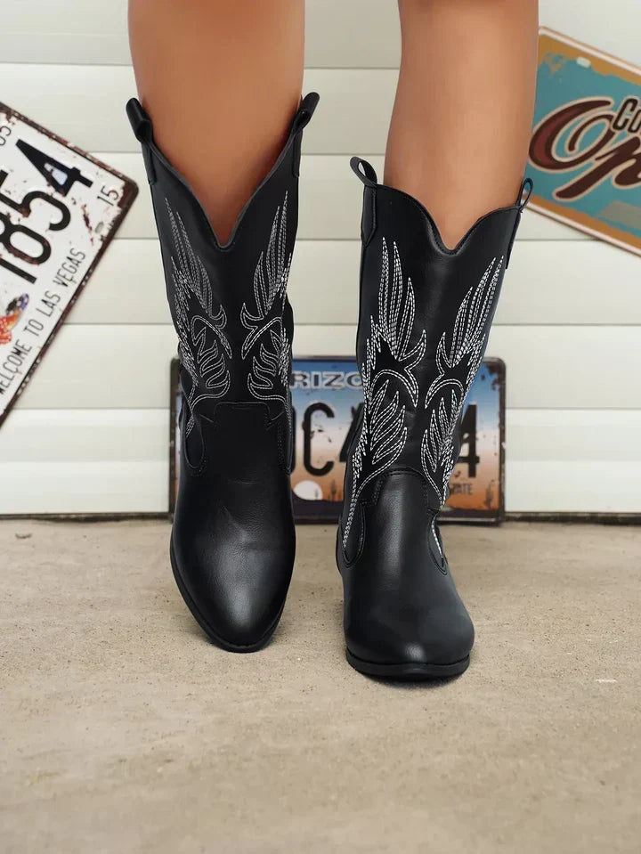 White women's mid-calf cowgirl boots. Fashionable pointed toe western boots with block heel for a trendy look.
