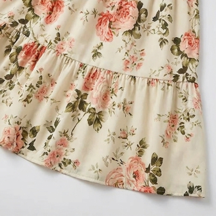 Party-ready women's floral smocked tiered midi dress, showcasing a stylish ruffle neckline.