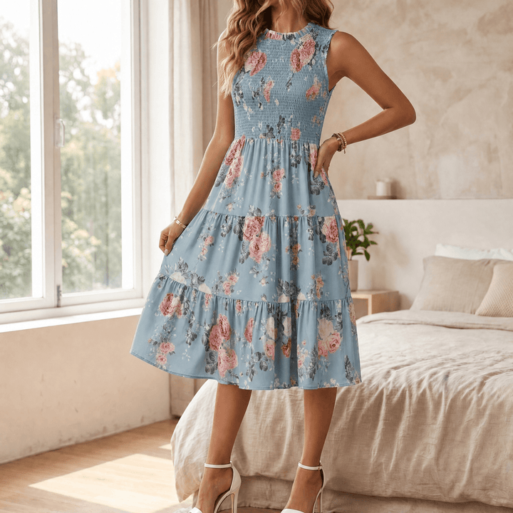 Woman wearing a flowing floral smocked tiered midi dress with a lovely ruffled neckline.