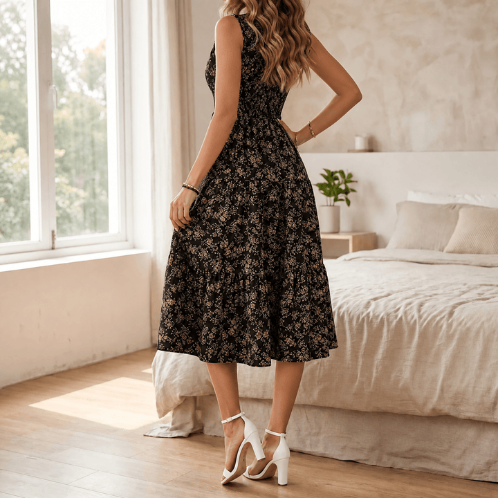 Boho-inspired women's floral tiered midi dress, smocked for comfort, detailed with a ruffled neckline.