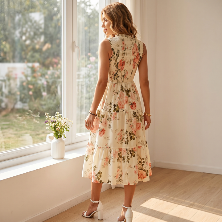 Full shot of a women's floral smocked tiered midi dress, ideal for summer parties and events.