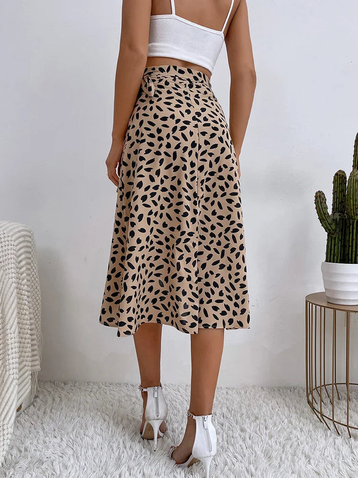 Stylish women's animal print midi skirt featuring a flattering tie waist and flowy asymmetric hem for a chic look.