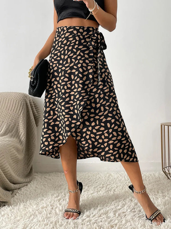 Casual-chic women's flowy animal print midi skirt. Comfortable tie waist and elegant asymmetric hem for summer style.