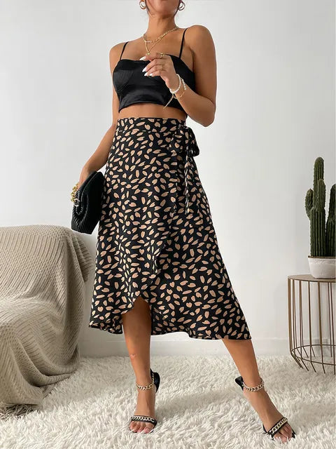 Women's fashionable animal print wrap midi skirt. Flowy design with a flattering tie waist and modern asymmetric hem.