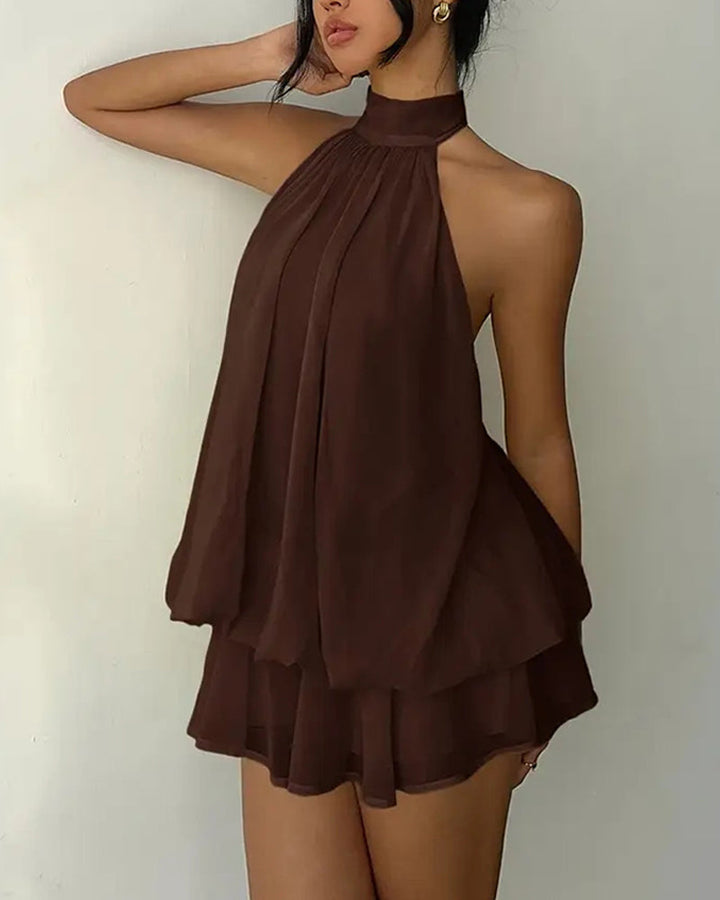 Women's mini dress with a tiered hem, halter neckline, and breezy open back for parties.