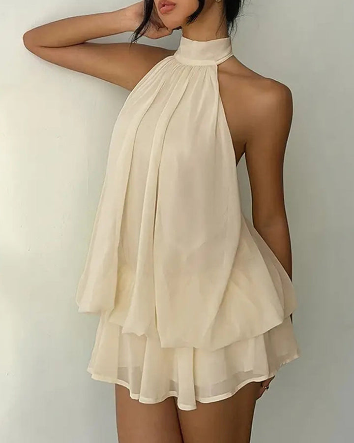 Women's summer mini dress, flowy fit, halter neck, and tiered hem, great for cocktails.