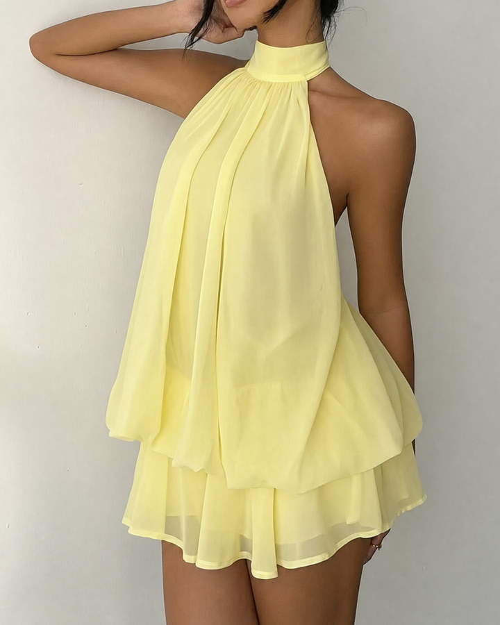 Summer fashion: women's cocktail mini dress with open back and delicate halter.