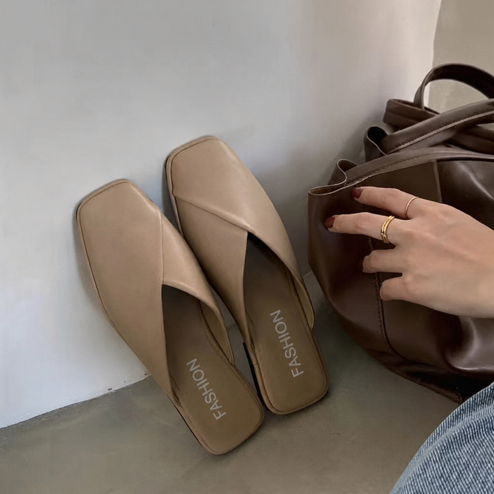 Women's black slip-on square toe mules, perfect for effortless everyday style and comfort.