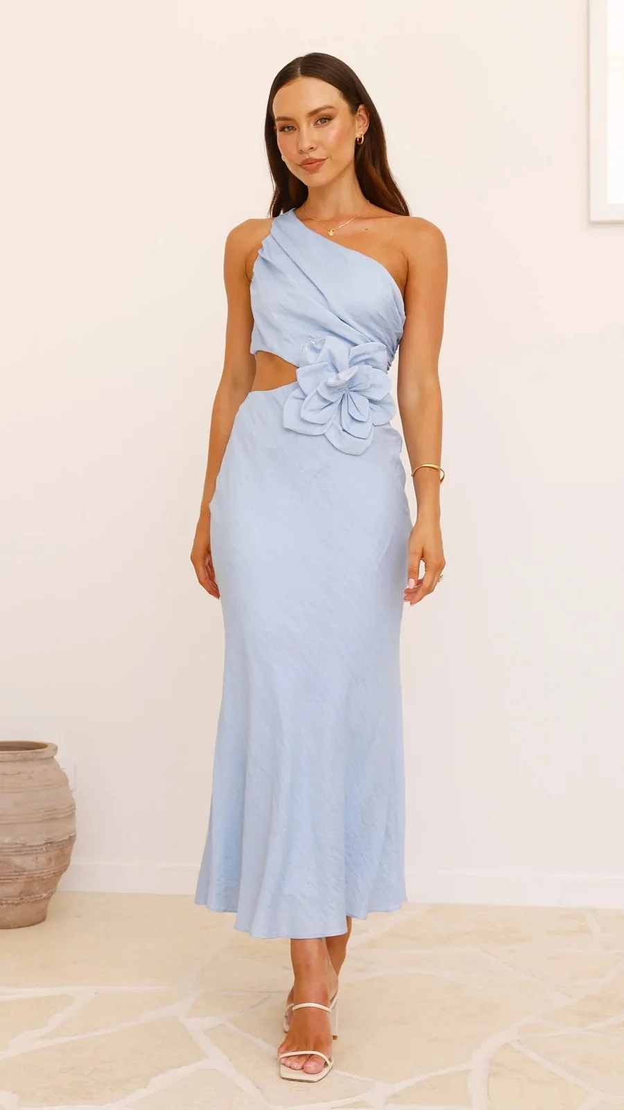 Showcasing the back of a women's one-shoulder cocktail dress with an elegant floral cutout design.