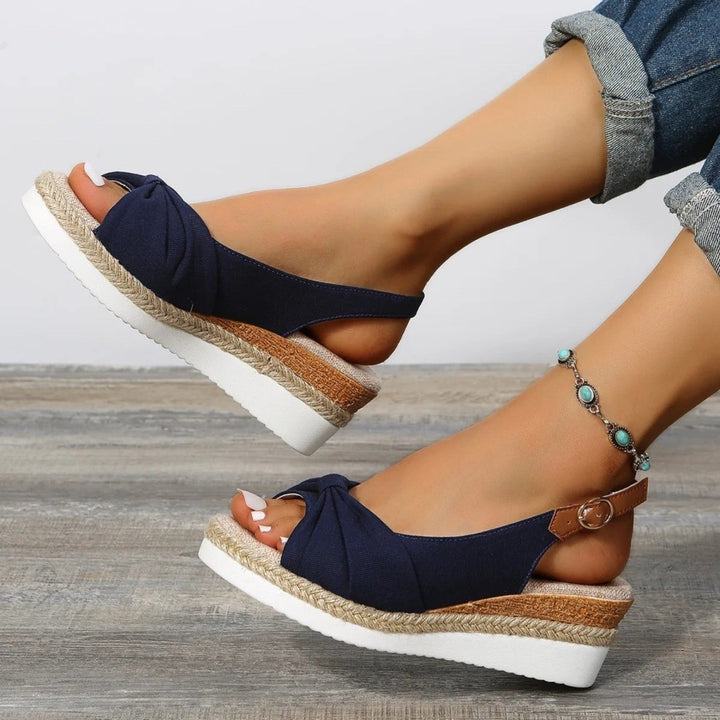 Elegant women's open-toe espadrille wedges, a comfortable platform slingback shoe for stylish summer wear.