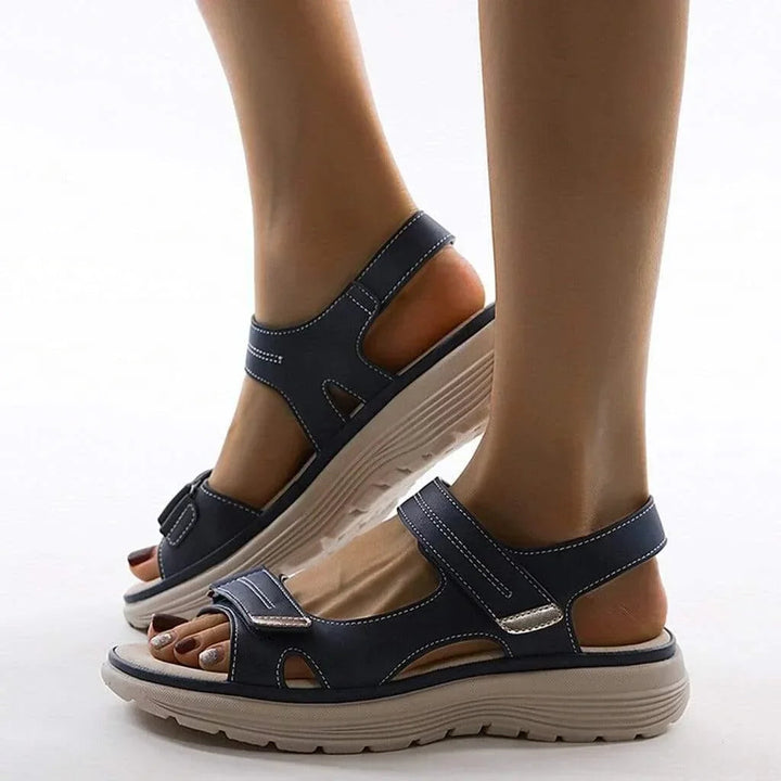 Active women's summer sandals with arch support, wide toe box, and secure adjustable straps.