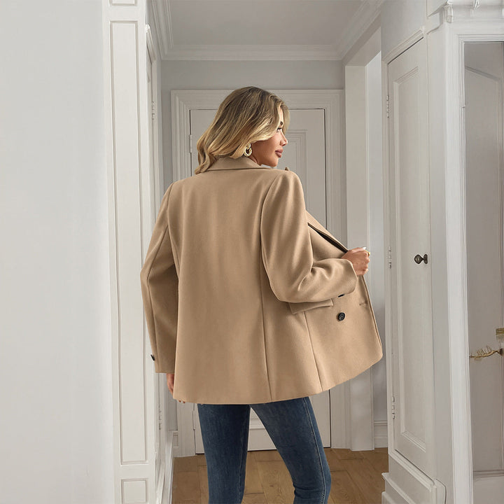 Double-breasted oversized khaki women's blazer featuring prominent lapels & flap pockets. Modern, chic layering jacket.