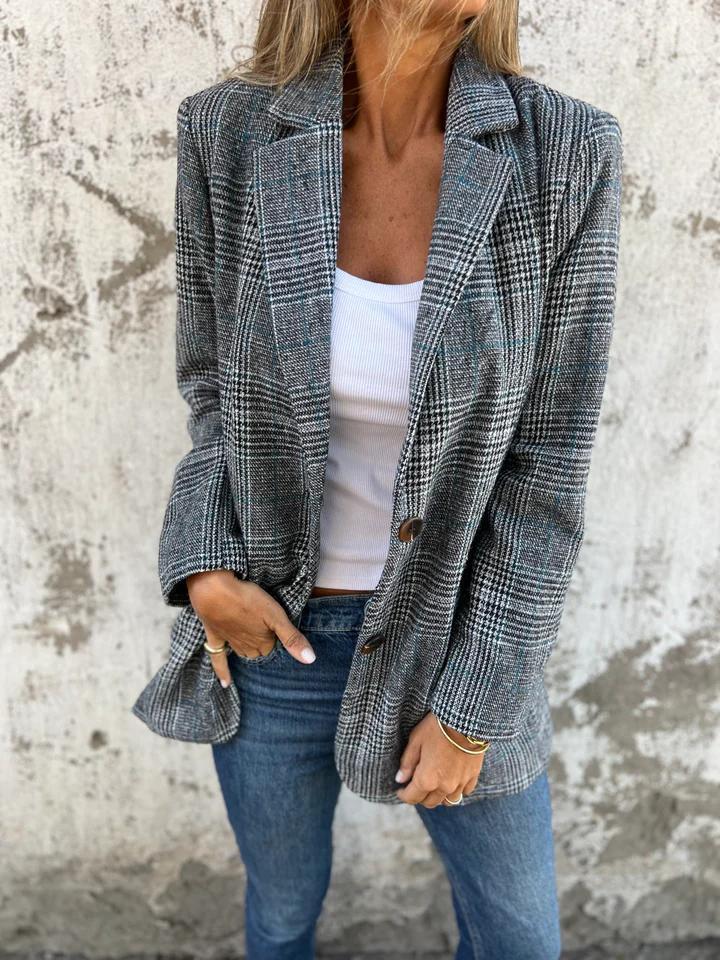 Chic women's oversized houndstooth blazer with a sophisticated notched lapel, perfect for smart casual or office wear.