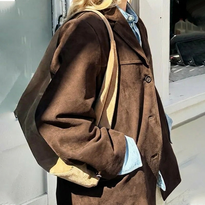 Brown oversized women's blazer with notched lapel. Versatile chic outerwear, ideal for office and casual elegant looks.