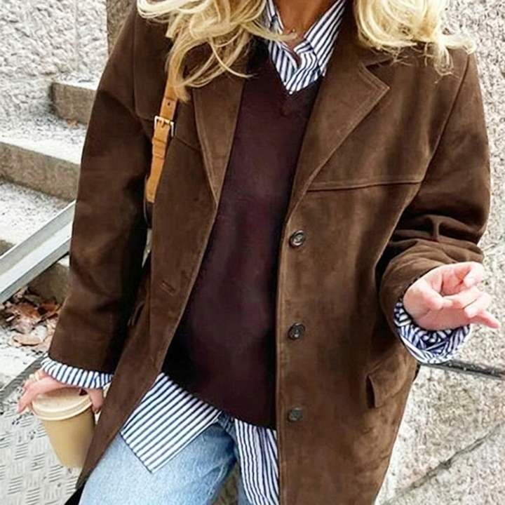 Elegant women's oversized brown blazer with notched lapel and button front. Modern & chic for any wardrobe.
