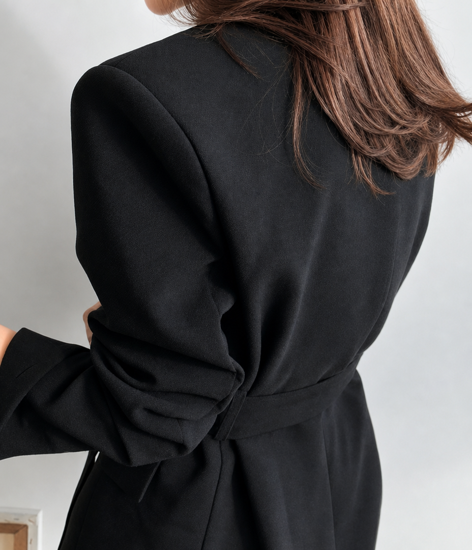 Women's versatile oversized black blazer dress. Features a plunge neckline & tie waist for a chic, sophisticated look.