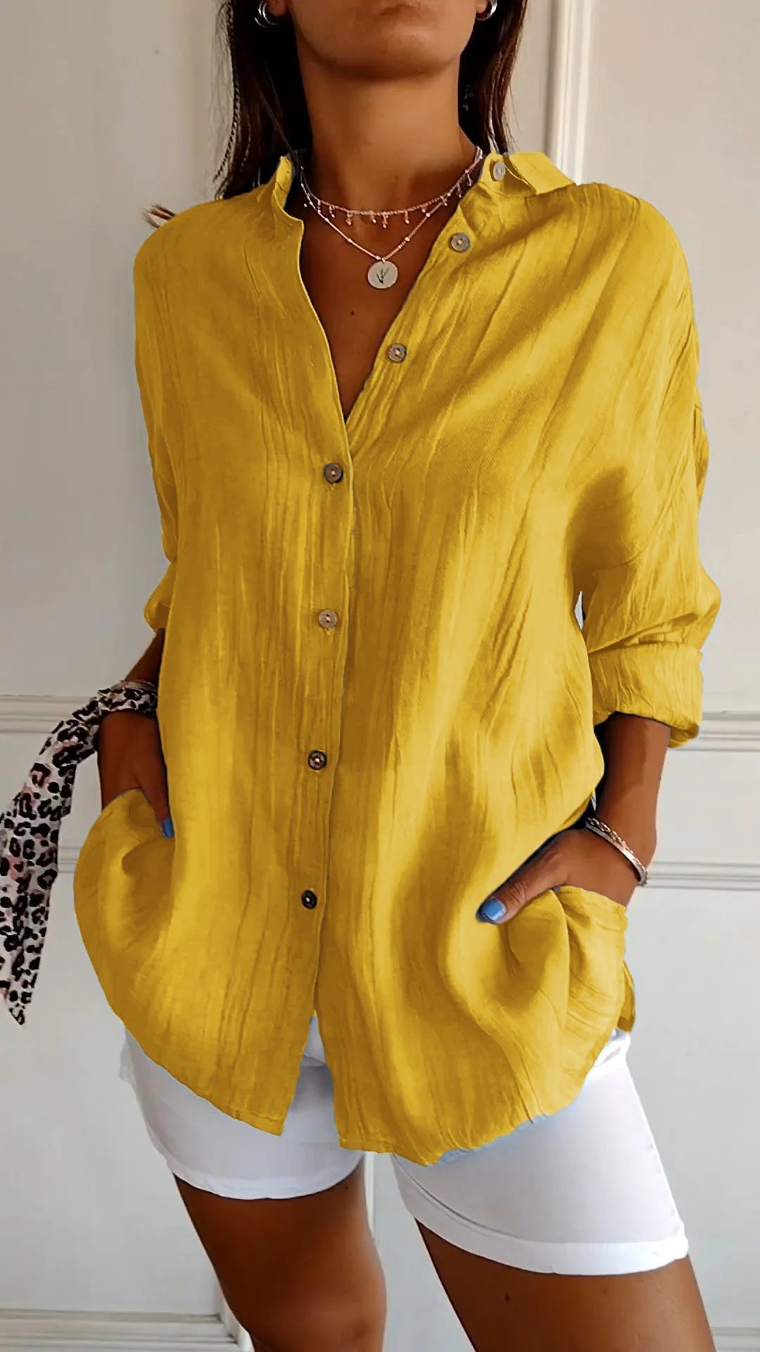 Model wearing a versatile womens relaxed fit long sleeve shirt