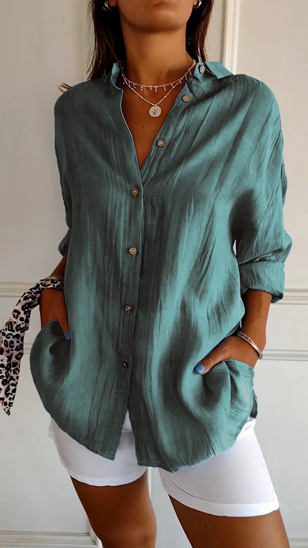 Detail of buttons on a womens relaxed fit long sleeve shirt