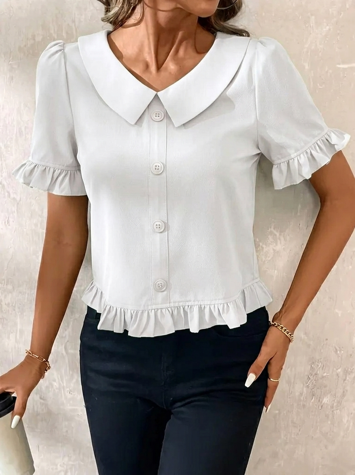 Sophisticated women's elegant blouse. Features a flattering ruffle hem, collar, and stylish puff sleeves.