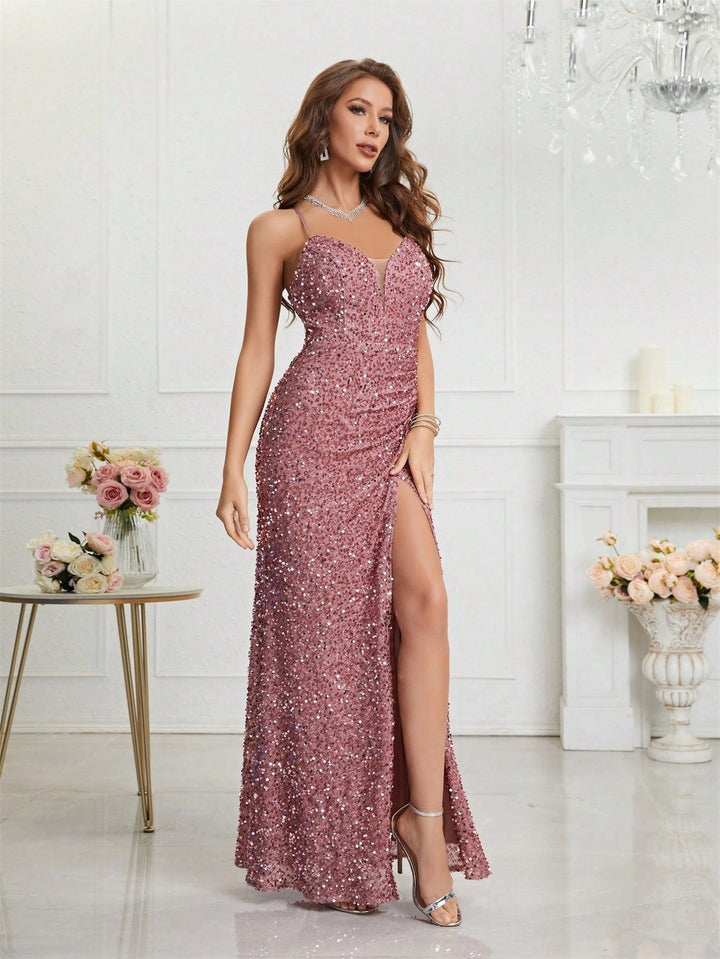 Chic women's sequin formal dress. Maxi silhouette, deep V-neckline, and an alluring leg slit.