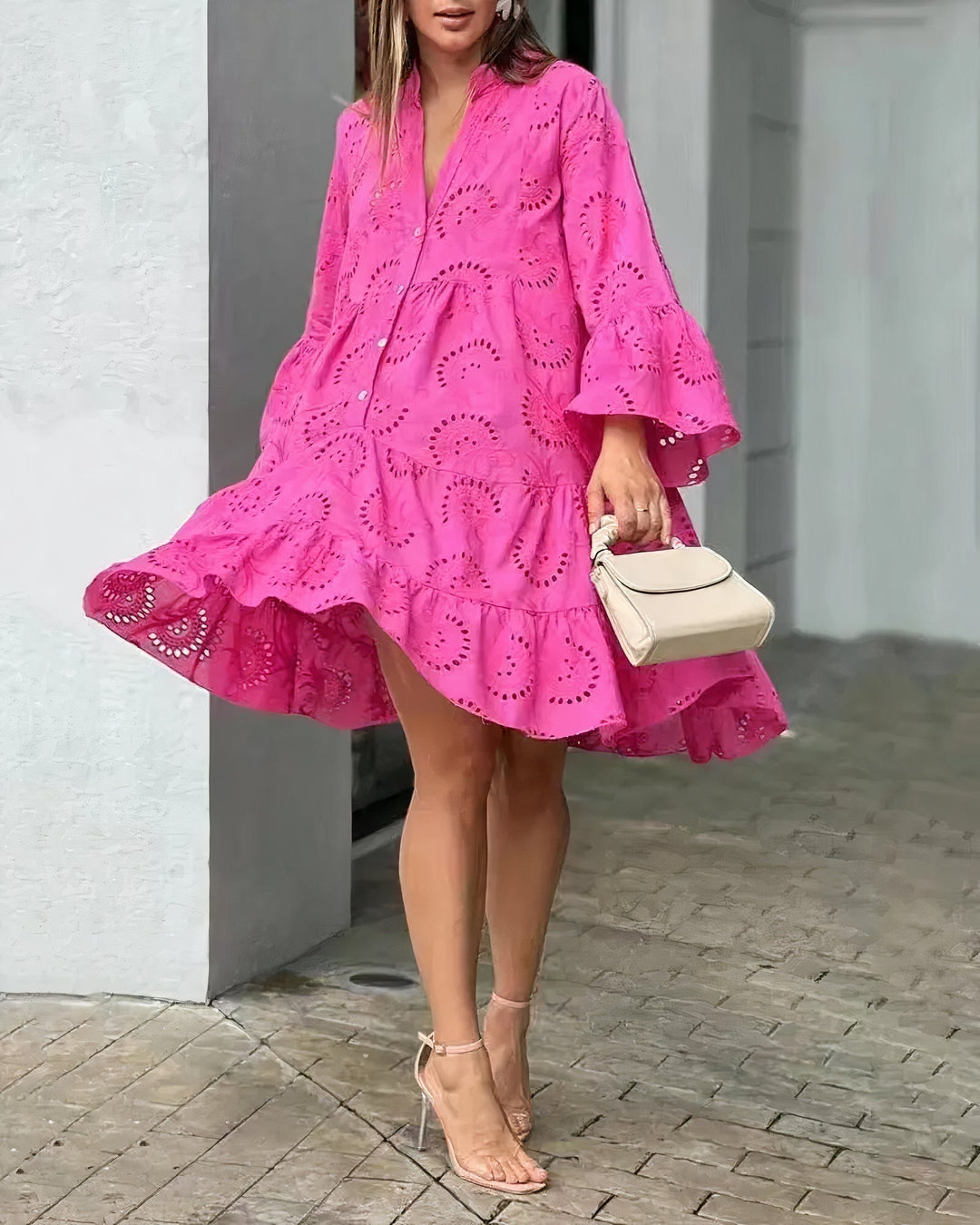 Women's white eyelet shirt dress with playful ruffle hem, V-neck, and delicate embroidery. Perfect summer mini dress.