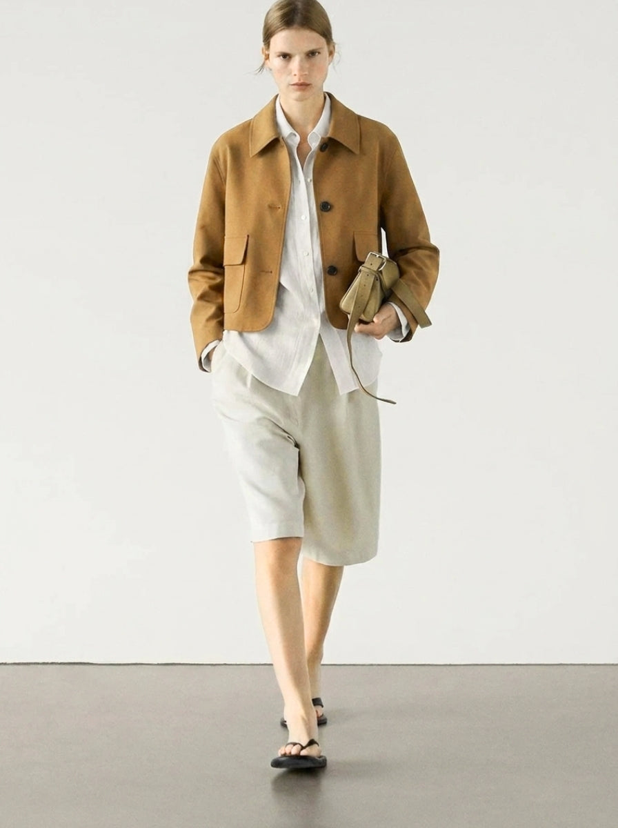 Chic cropped suede jacket for women, featuring a button-up design & fashionable patch pockets, ideal for spring outerwear.