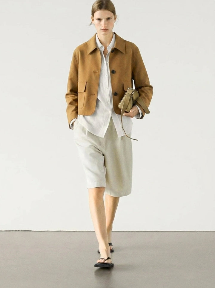 Chic cropped suede jacket for women, featuring a button-up design & fashionable patch pockets, ideal for spring outerwear.
