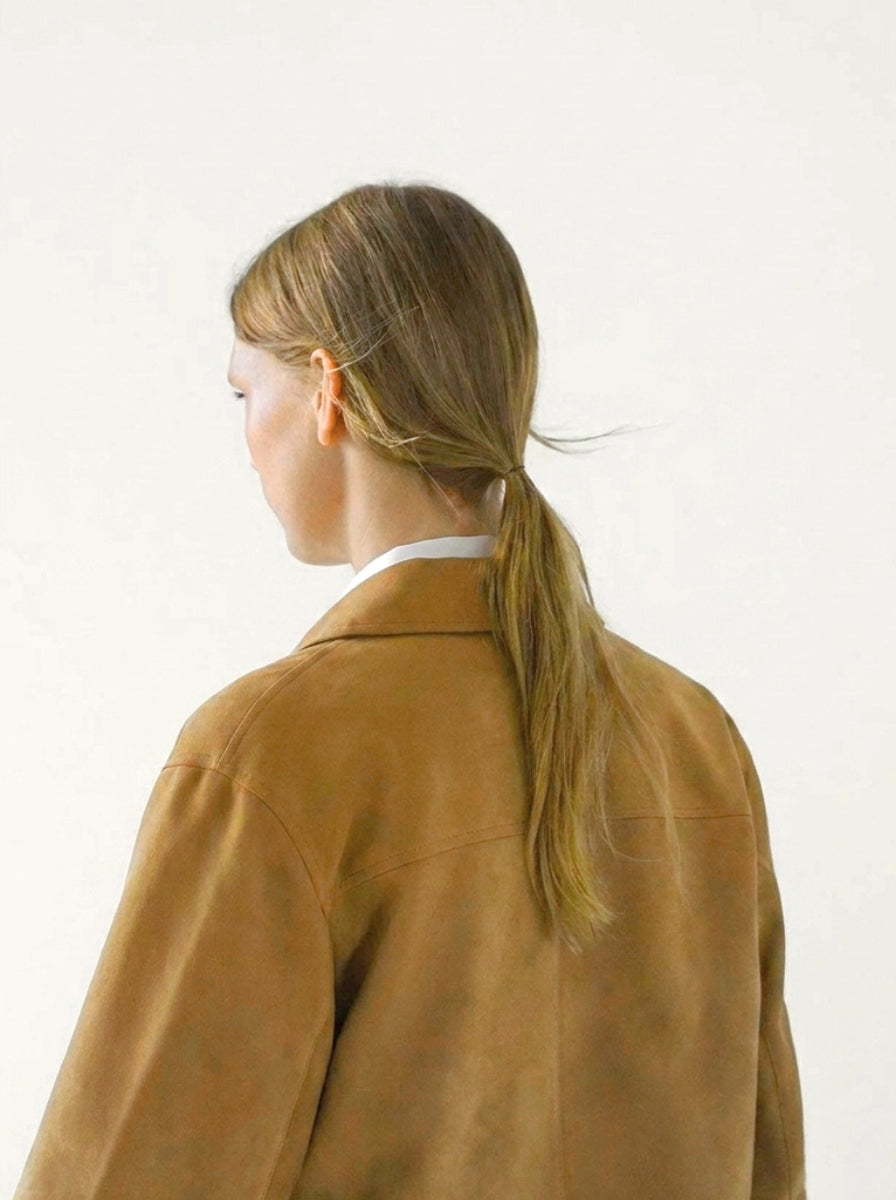 Elegant button-up cropped suede jacket for women. Features stylish patch pockets, ideal for versatile casual outerwear.