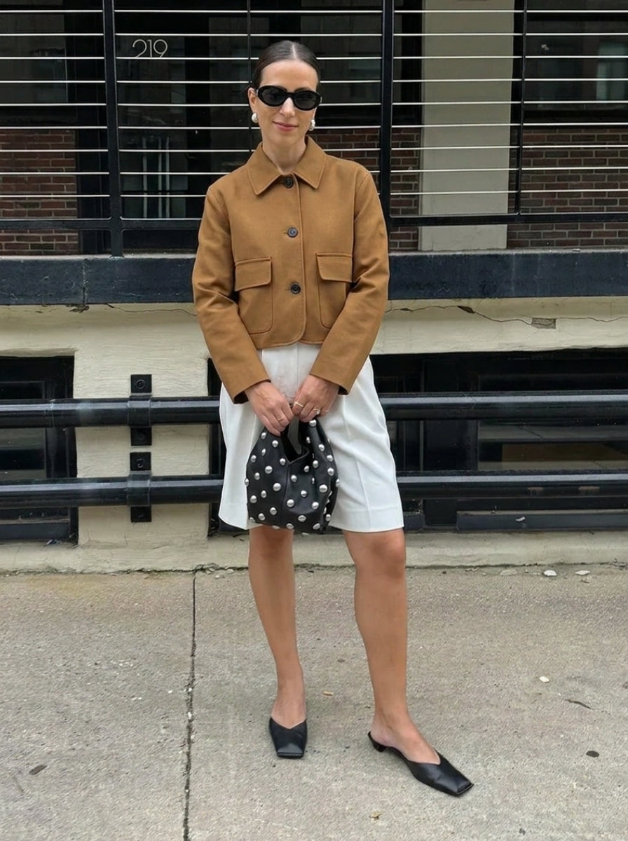 Stylish women's cropped suede jacket, a button-up design with fashionable patch pockets for modern everyday outerwear.