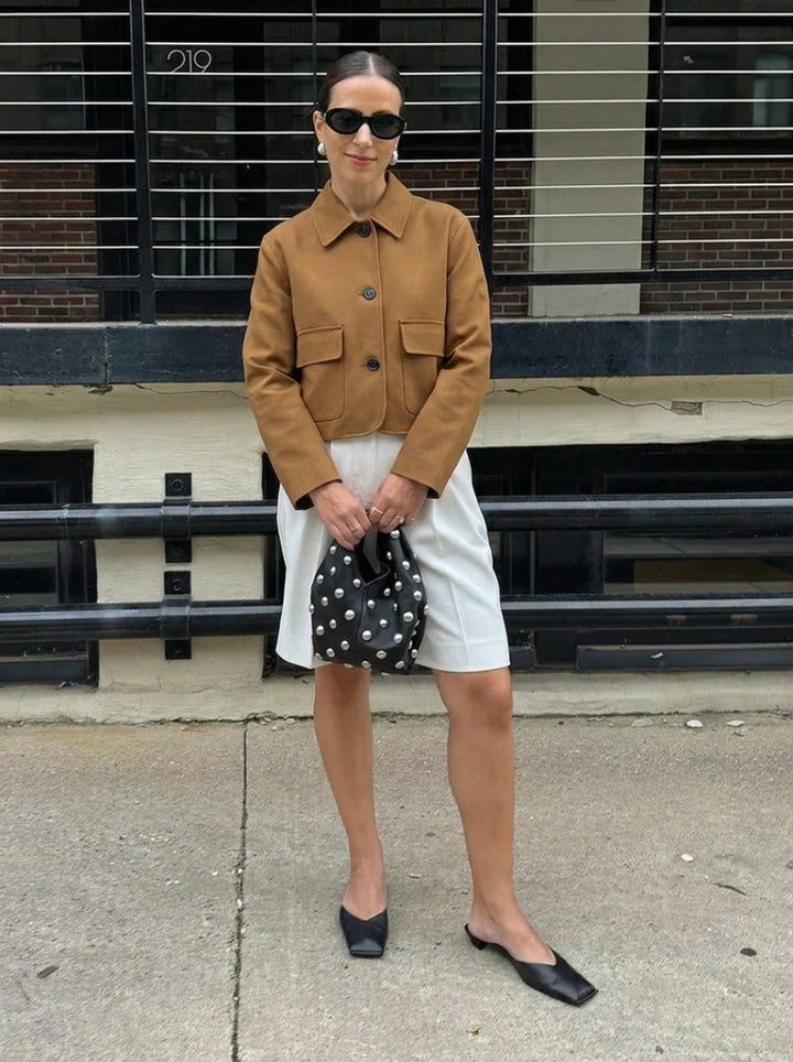 Stylish women's cropped suede jacket, a button-up design with fashionable patch pockets for modern everyday outerwear.