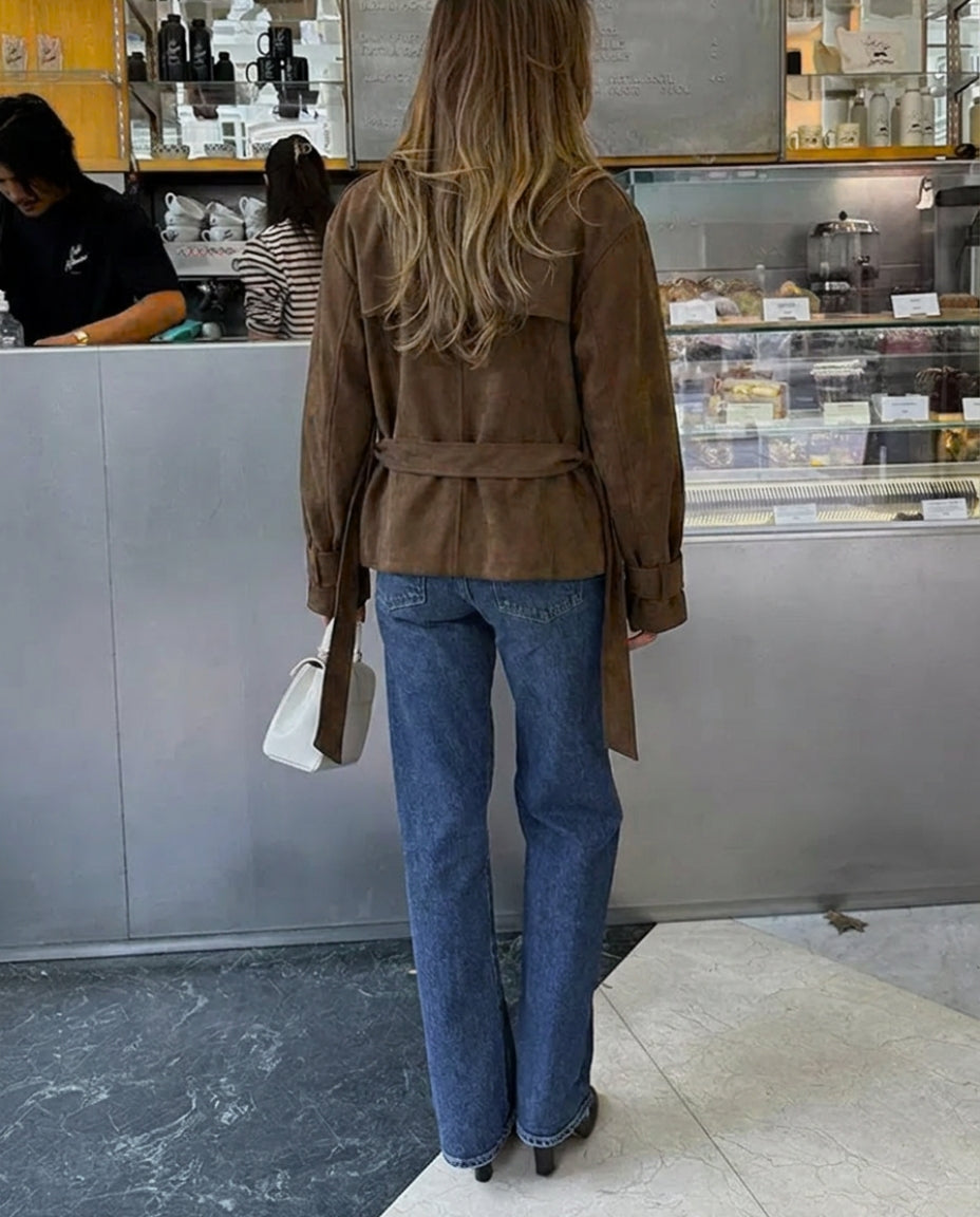 Chic women's suede jacket in retro style, showcasing a belted design and elegant notched lapel.