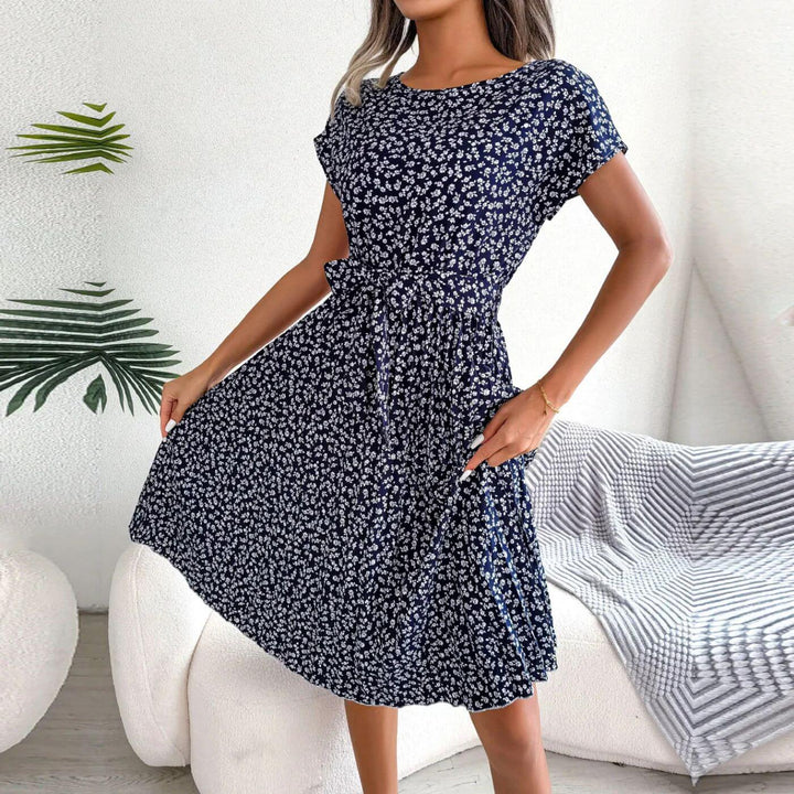 Women's summer midi dress with beautiful floral print & adjustable tie waist, perfect for sunny days.