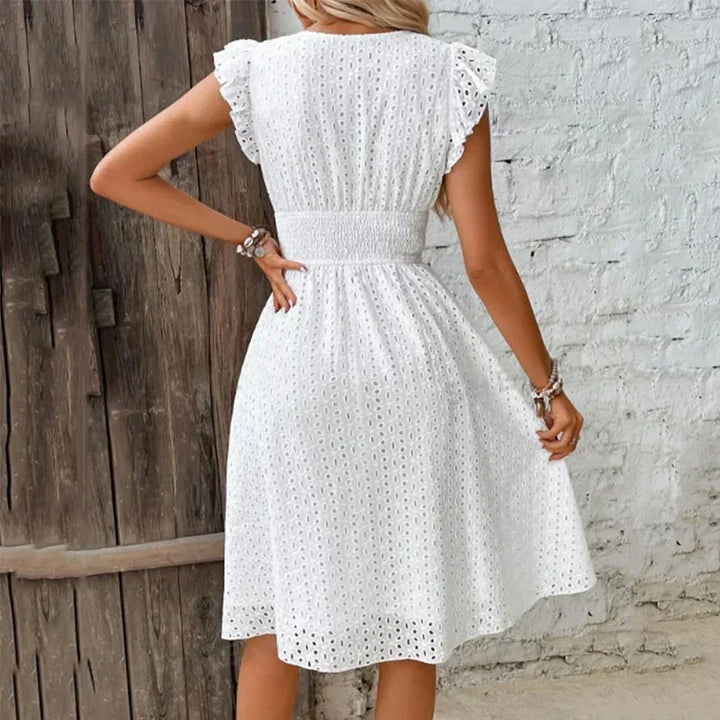 Casual women's flowy eyelet midi dress with V-neck & smocked waist, ideal for summer vacation or beach.