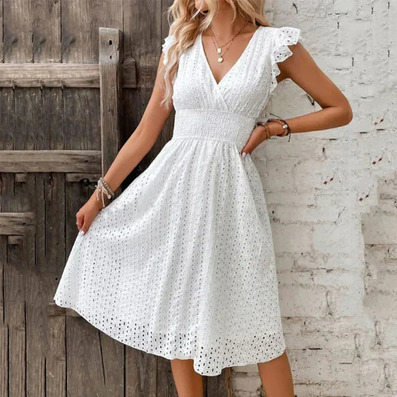 Comfortable V-neck eyelet midi dress for women, featuring flowy design, smocked waist & delicate ruffled sleeves.
