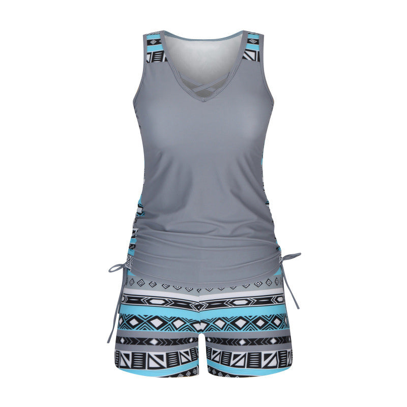 Women's criss-cross tankini top & patterned shorts, perfect for a relaxing beach vacation.