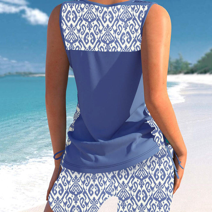 Must-have vacation swimwear: women's criss-cross tankini top & stylish patterned shorts for summer.