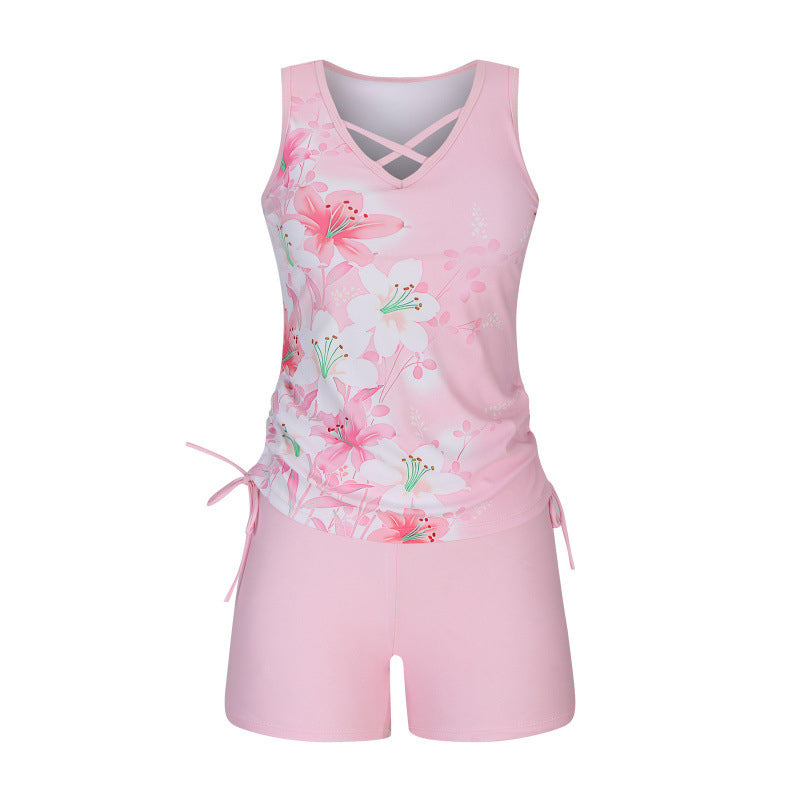 Complete look: women's criss-cross tankini top & patterned shorts, versatile summer swimwear.
