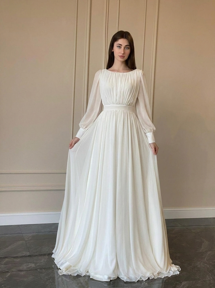 Elegant women's white flowy long sleeve wedding dress, perfect for graceful brides. Classic bridal gown for formal occasions.