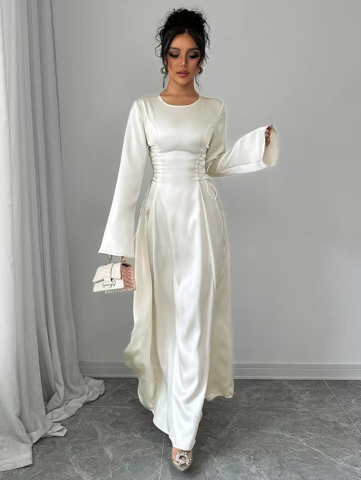 Women's white formal maxi dress with unique bell sleeves and elegant design, ideal for special occasions.