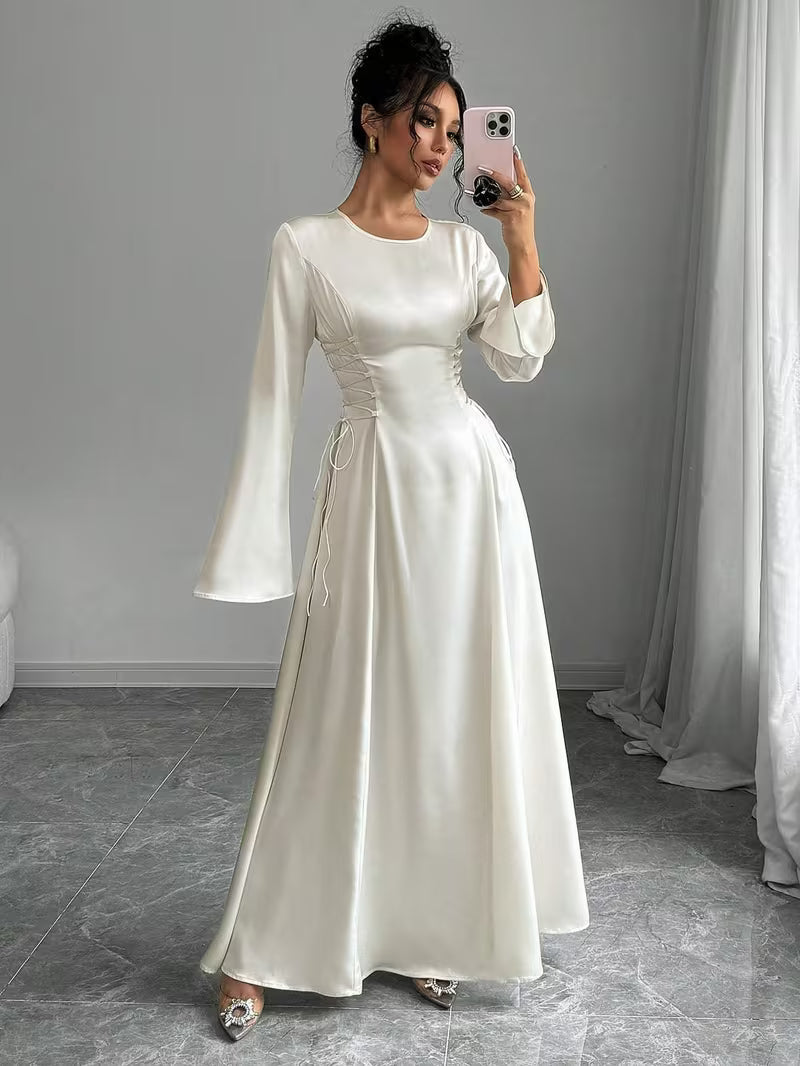 Stunning long white formal dress for women, featuring graceful bell sleeves and a flowing maxi silhouette.