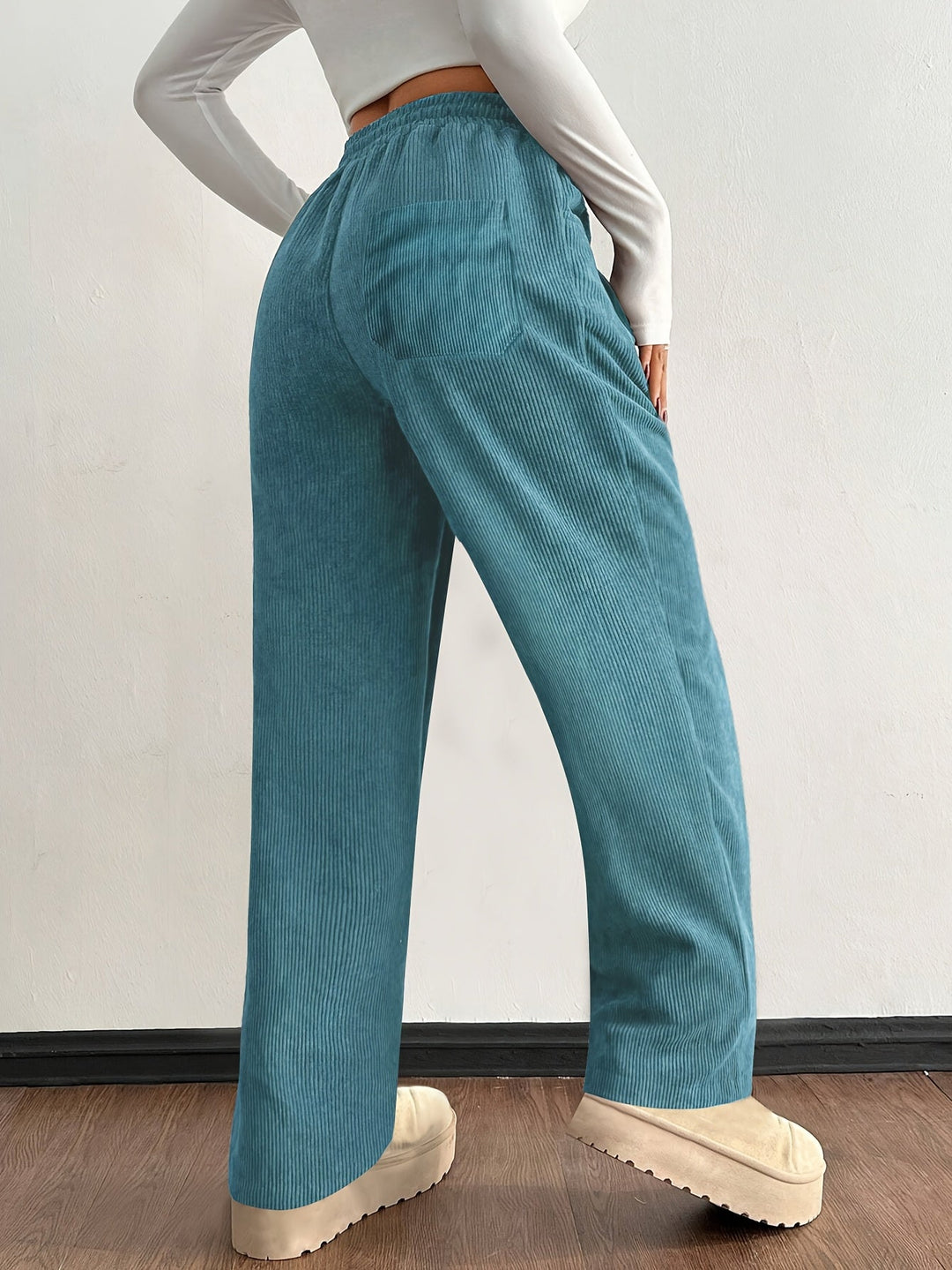 Relaxed fit women's wide leg corduroy pants. Comfortable baggy design with functional pockets for streetwear.