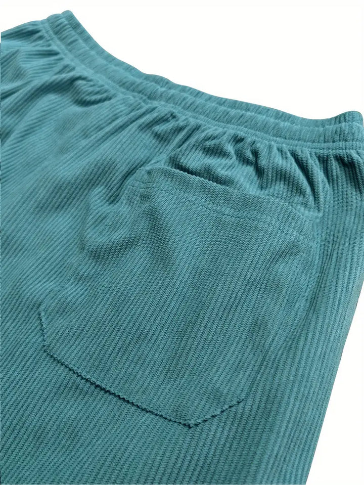 Soft corduroy women's baggy wide leg pants featuring an adjustable drawstring waist. Trendy & loose fit.