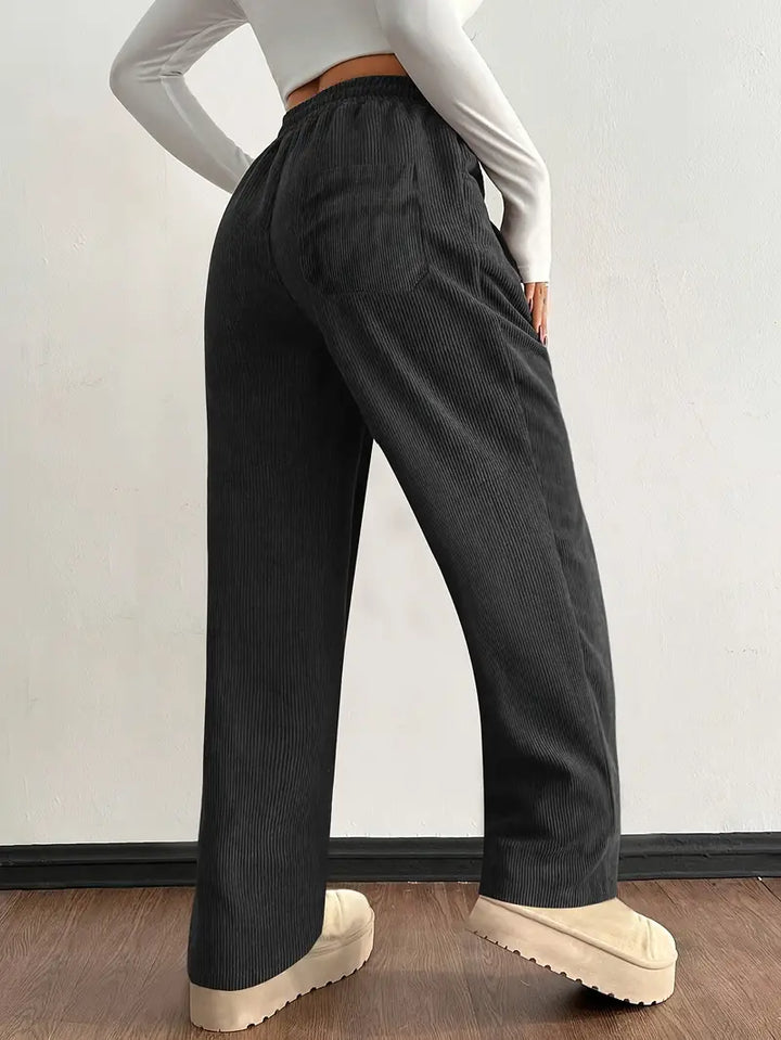 Close-up of soft corduroy fabric on women's baggy wide leg pants, showing drawstring waist & deep pockets.
