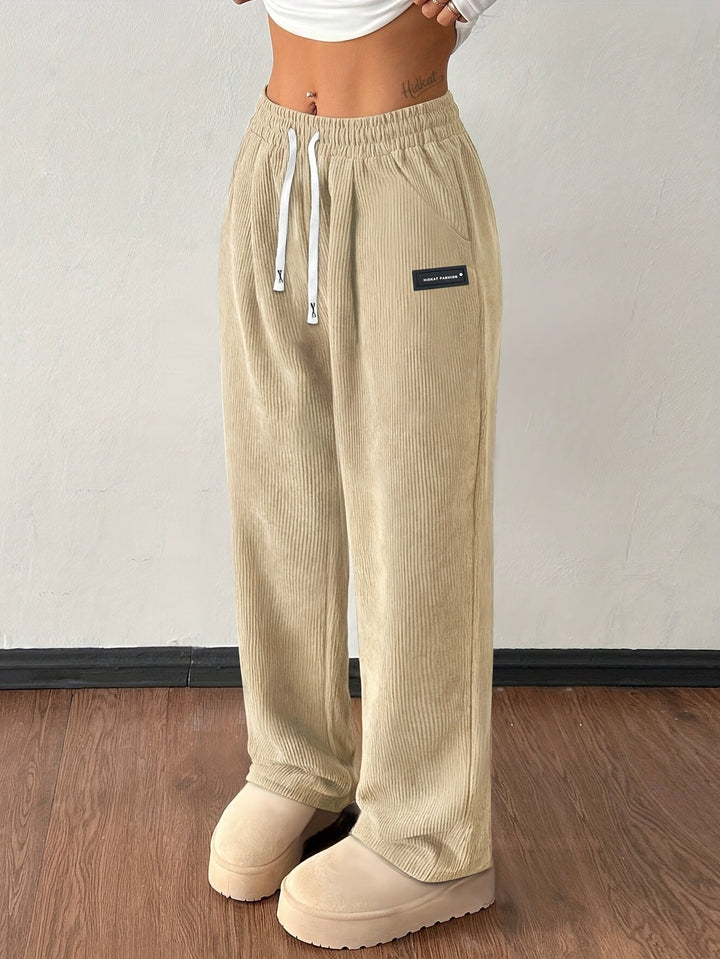 Back view of women's baggy wide leg corduroy pants, highlighting loose fit, soft texture & back pockets detail.