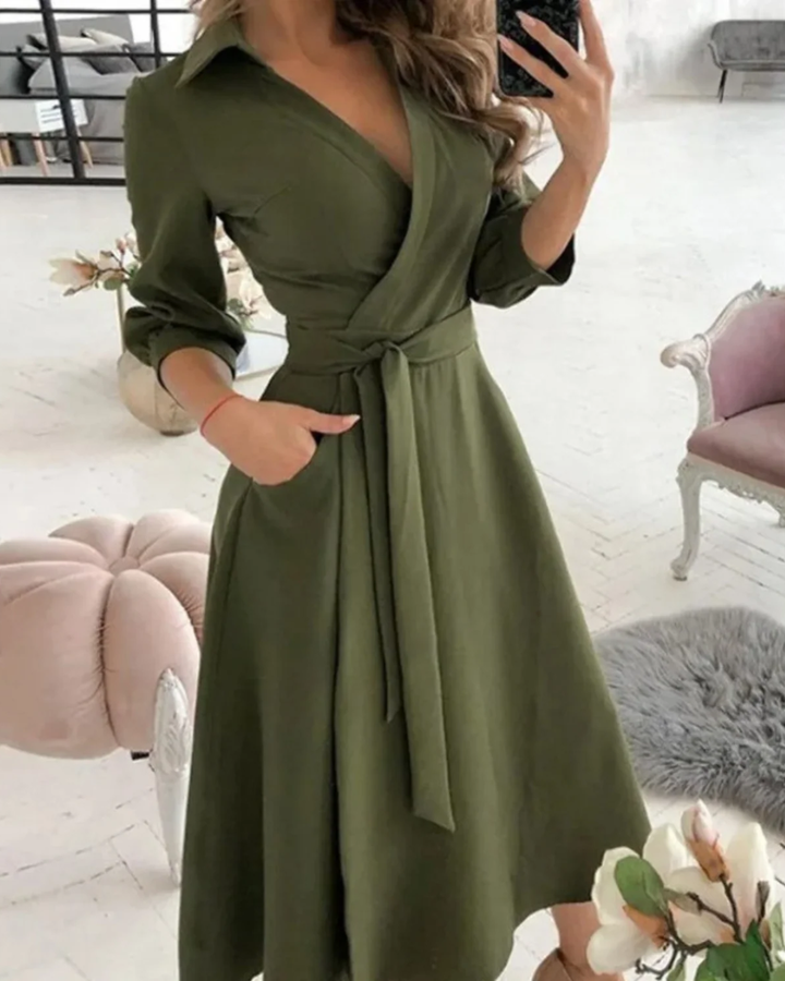 Chic women's elegant wrap dress with three-quarter sleeves & tie waist; a professional midi for work.