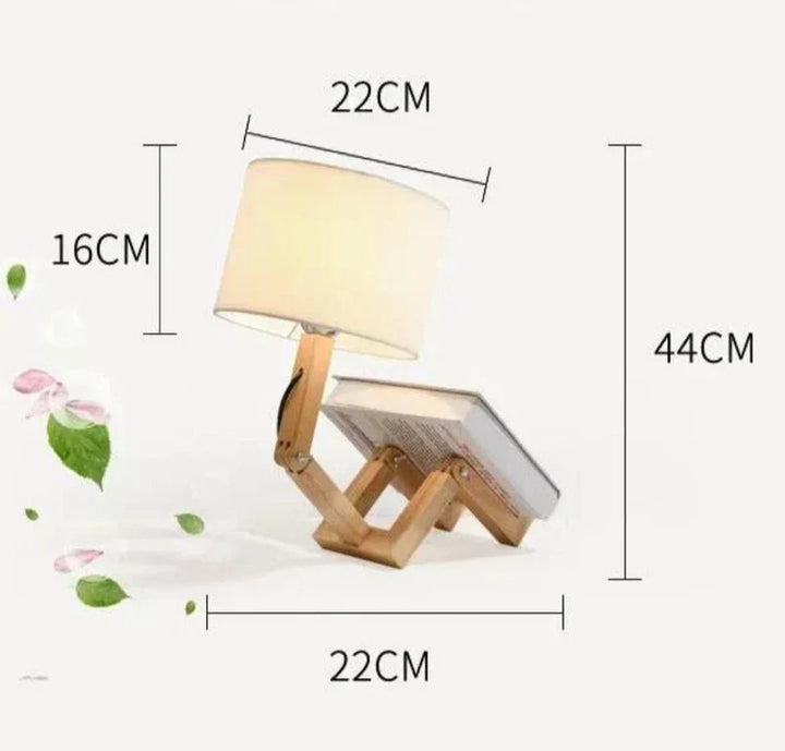 Functional wooden robot reading lamp, adjustable, with integrated book holder. Ideal for bedroom or study.