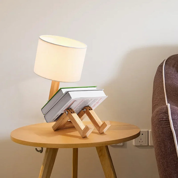 Convenient wooden robot table lamp, adjustable for optimal reading light. Features an integrated book holder.