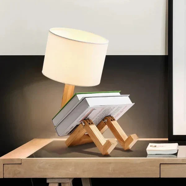 Handcrafted wooden robot lamp, a modern table light with fabric shade & book holder. Great for desks.